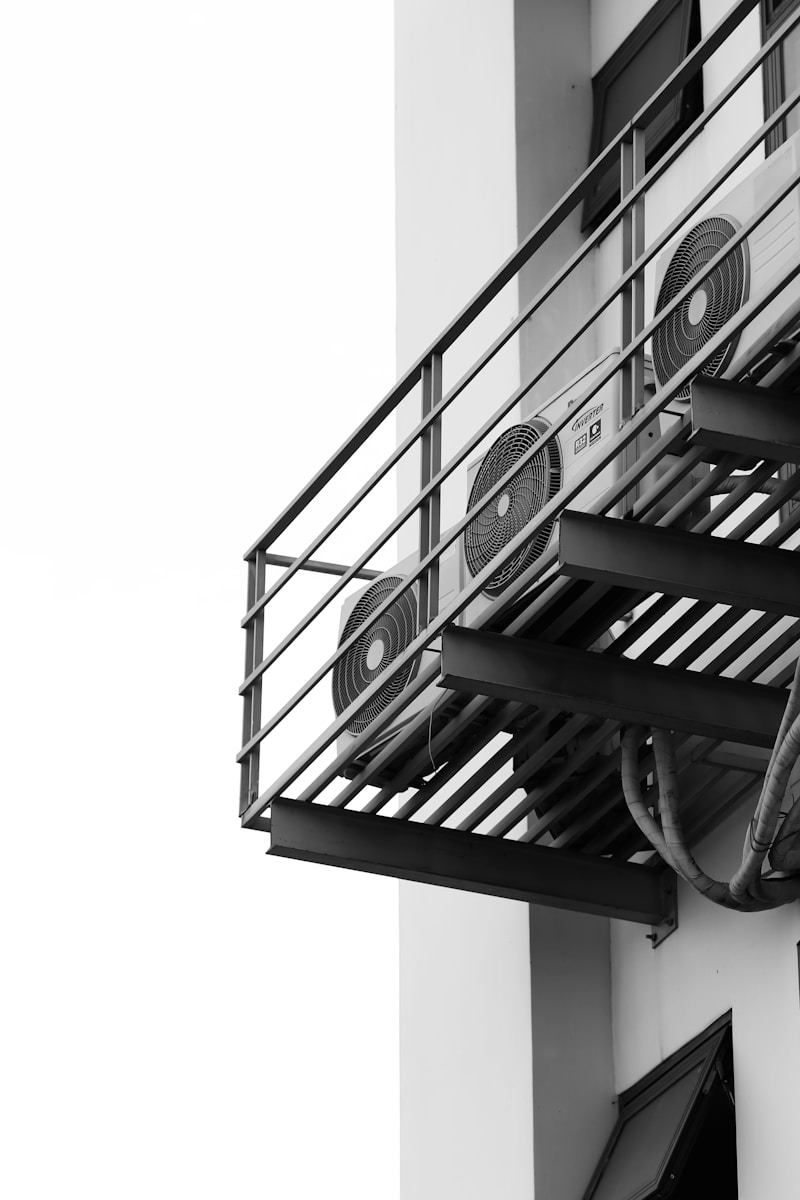 a black and white photo of a clock on a building